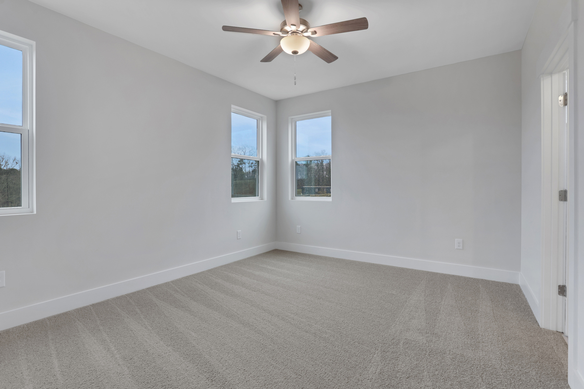 primary bedroom with ensuite bath and windows