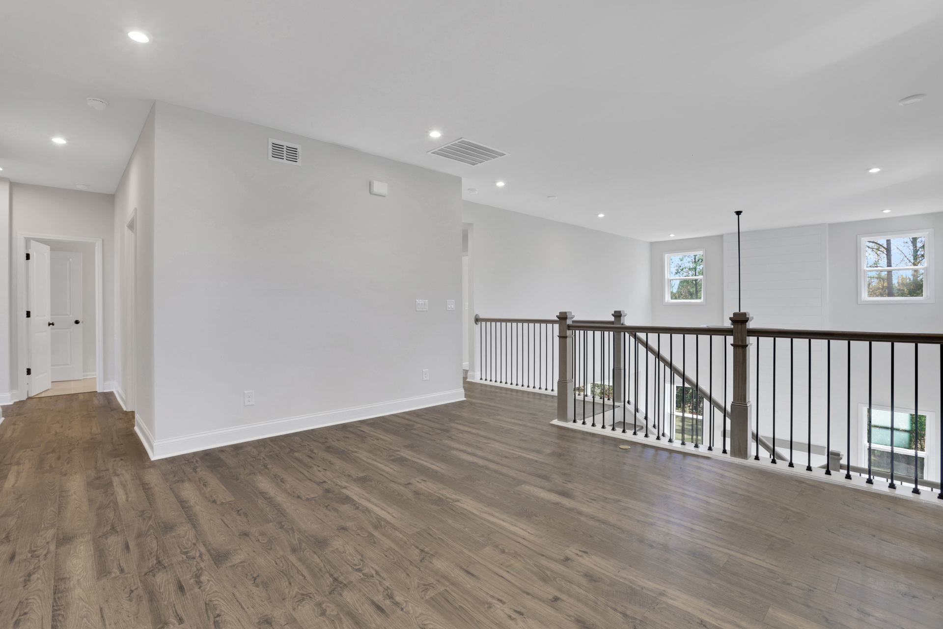 loft with hard-surface flooring overlooking 2-story great room