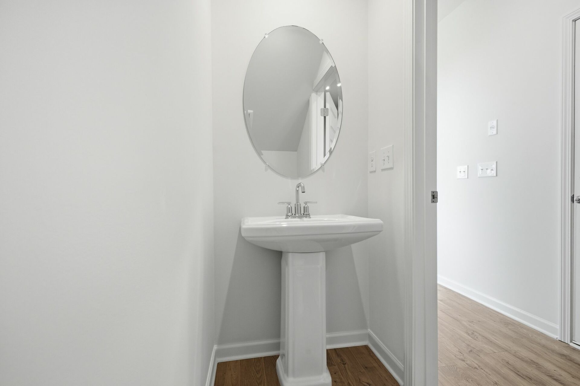 secondary bathroom powder room with standing sink and oval window