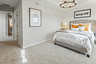 primary bedroom with carpet, chandelier, light walls, white trim