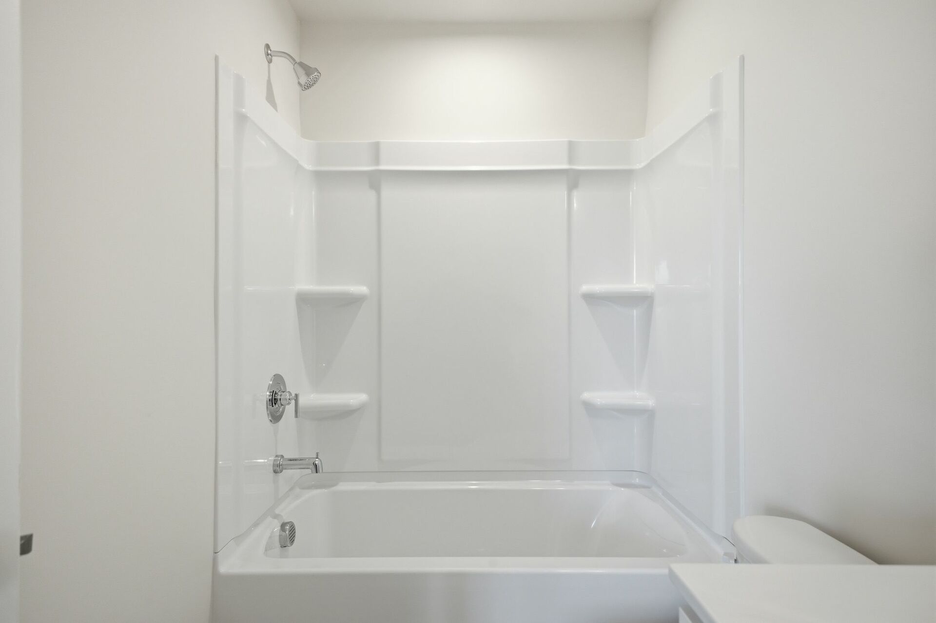secondary bathroom with large tub, single-sink vanity with white counters and cabinets, polished chrome hardware