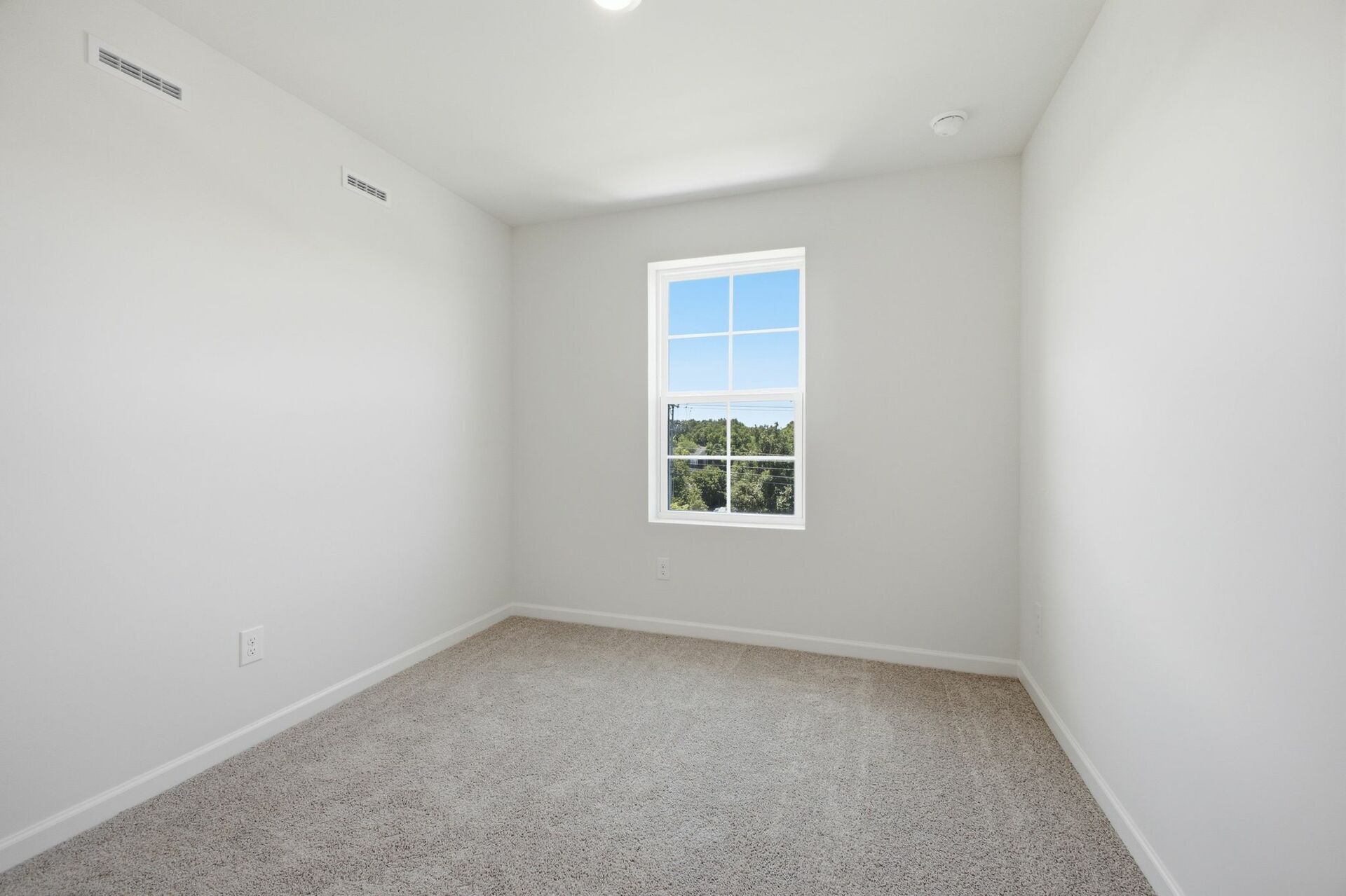 secondary bedroom with carpet, large windows, and double door closet