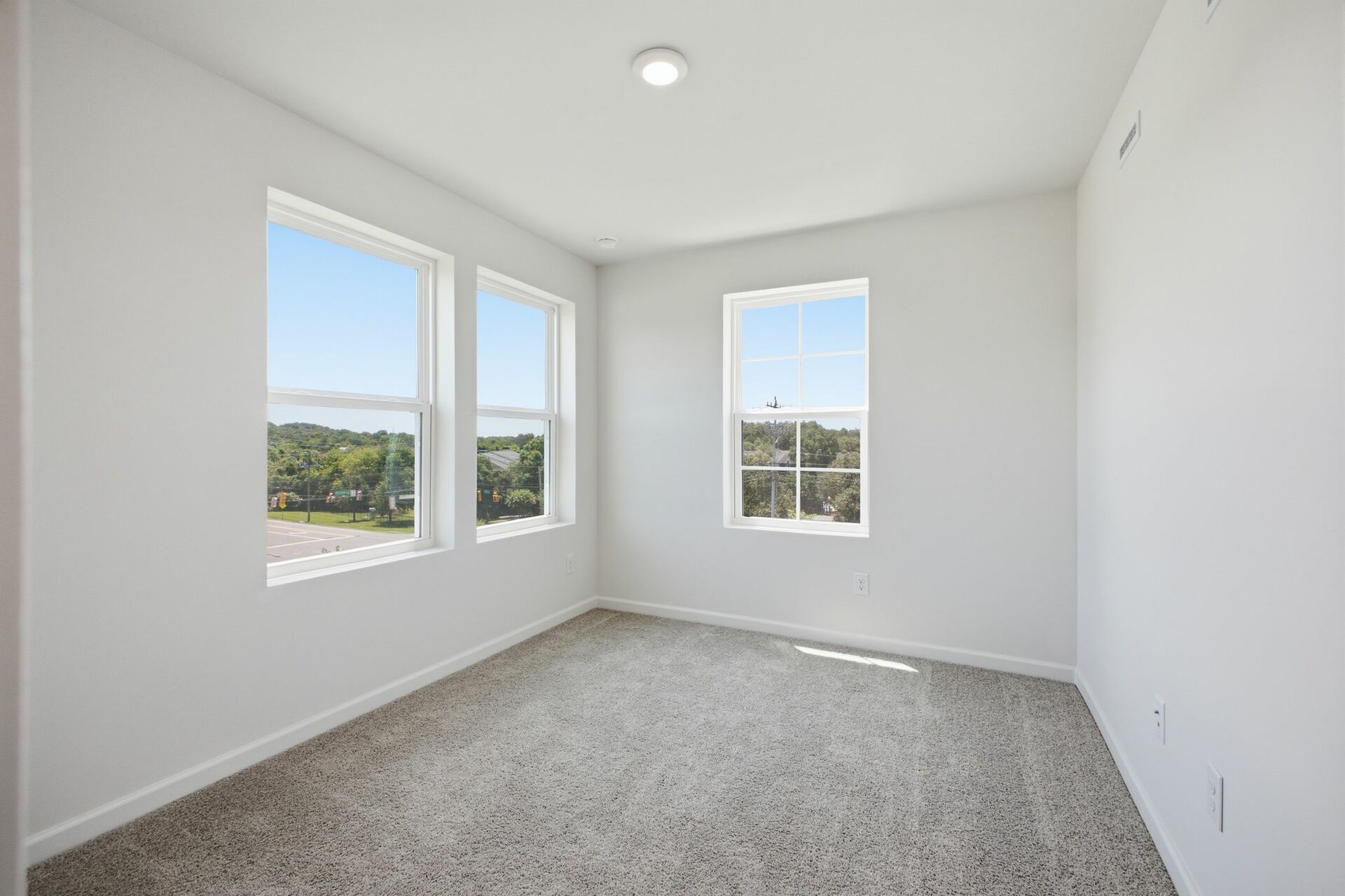 secondary bedroom with carpet, large windows, and double door closet