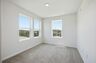 secondary bedroom with carpet, large windows, and double door closet