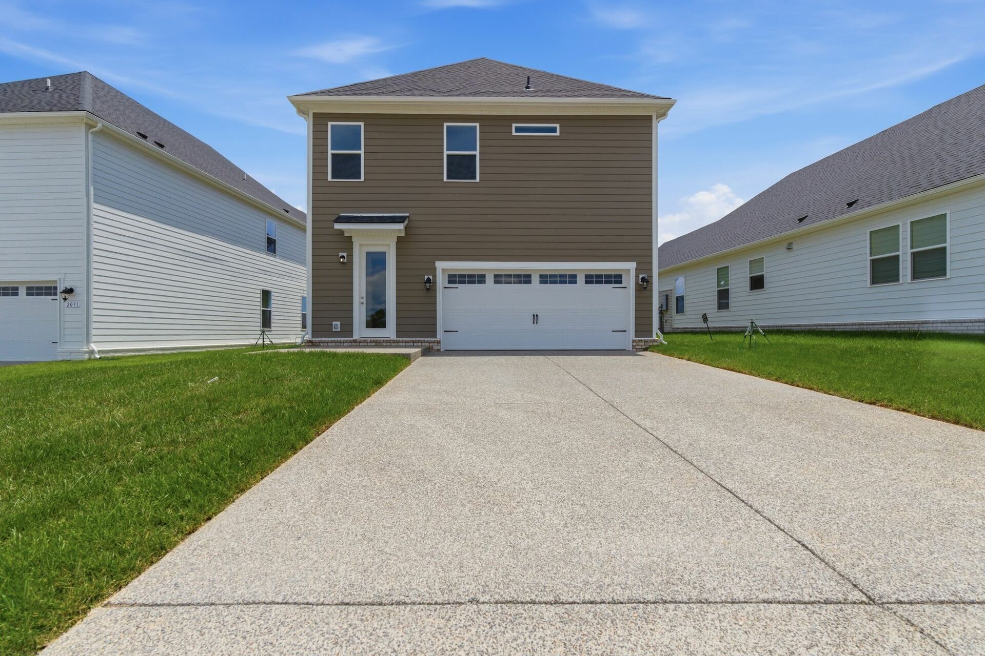 home exterior with back patio and two car garage