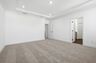 primary bedroom with carpet, tray ceiling, and attached bathroom