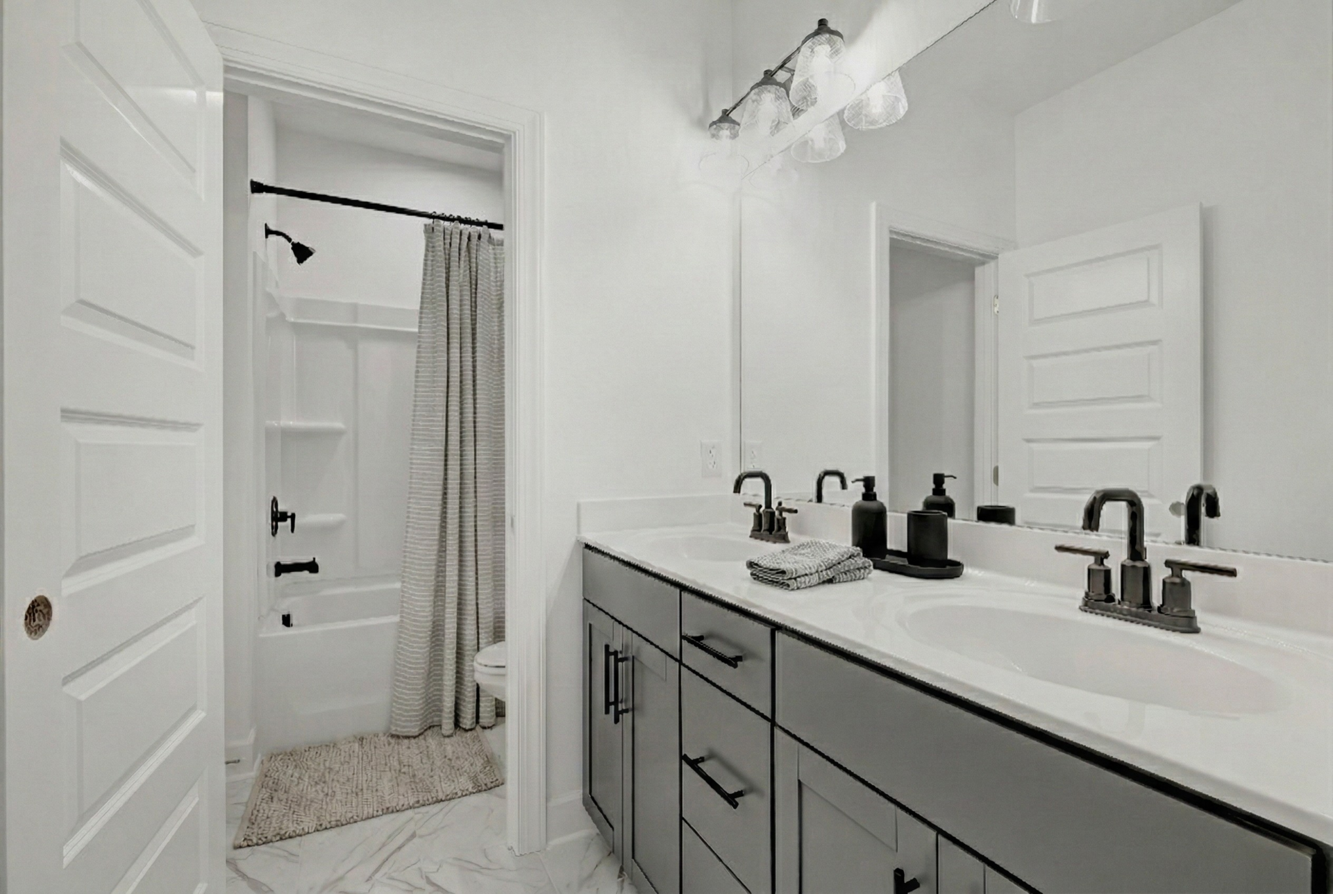 secondary bathroom with double sink vanity, tile flooring, and a shower and tub combination