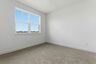 secondary bedroom with carpet, large windows, and walk-in closet
