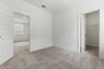 secondary bedroom with carpet, large windows, and walk-in closet