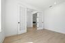 study with wood floors, large windows, and french doors