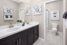 bathroom with neutral tile floors and white countertops