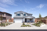 exterior of two-story home with desert landscaping and white garage