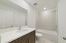 single sink vanity, water closet and shower
