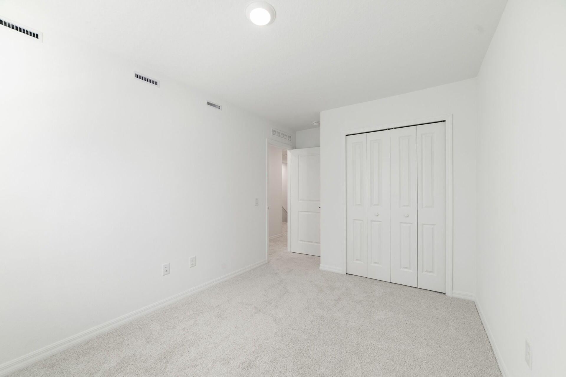 room with carpet throughout and large single window and closet in the room 