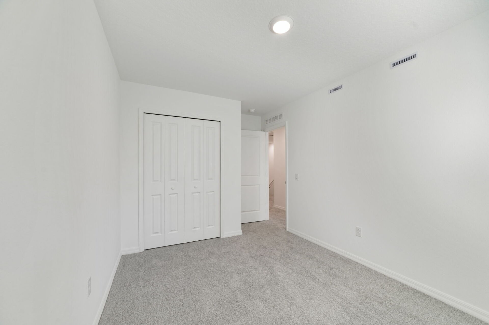 room with carpet throughout single window and access to the closet
