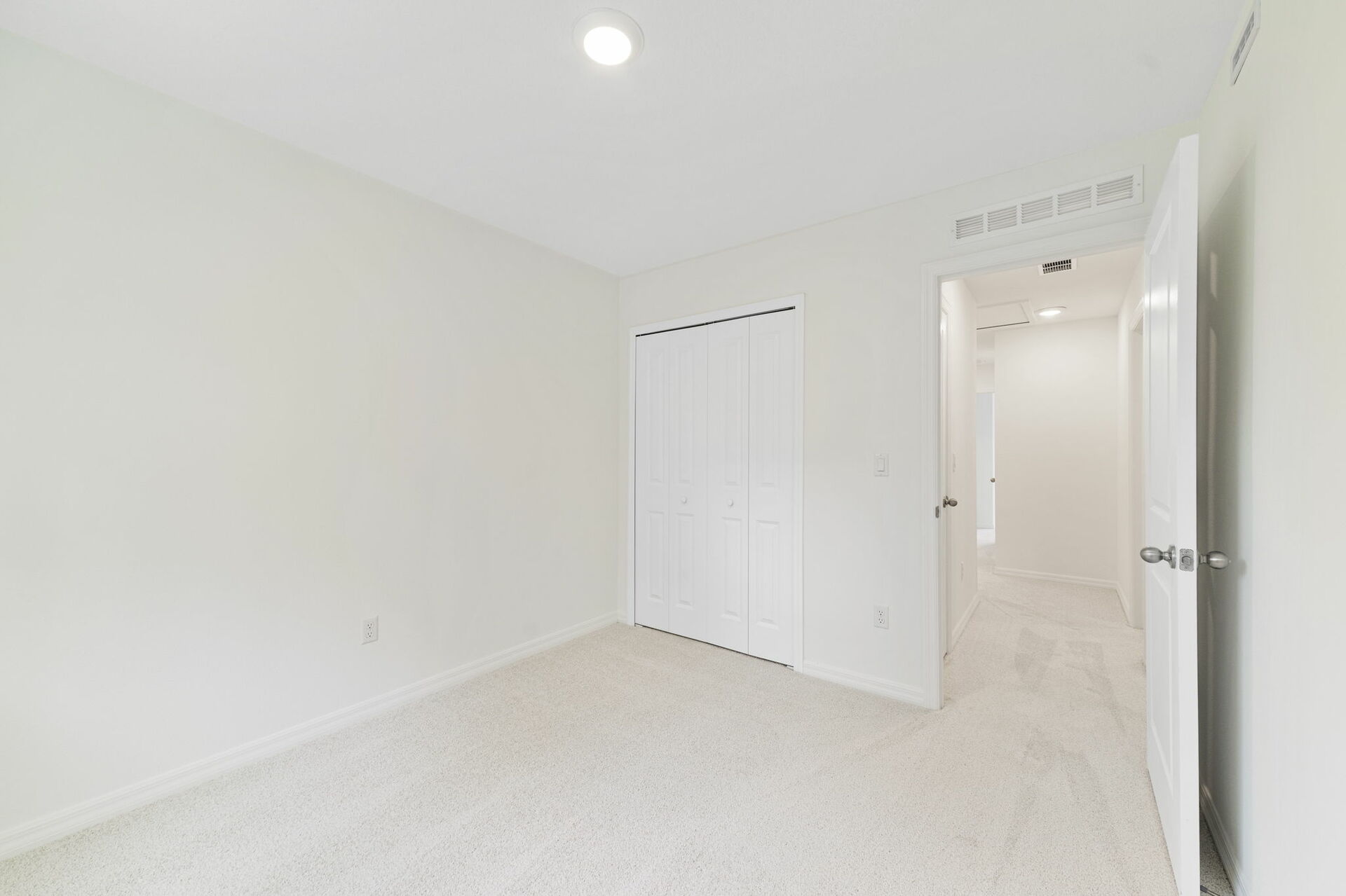 carpet throughout with a single window and carpet