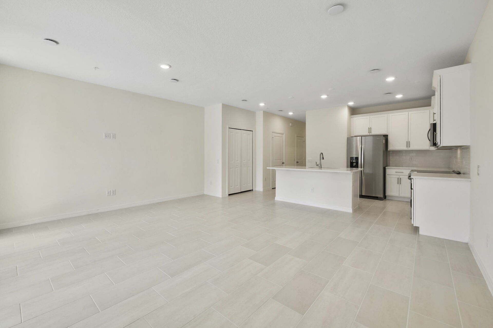 room with access to lanai and view of kitchen