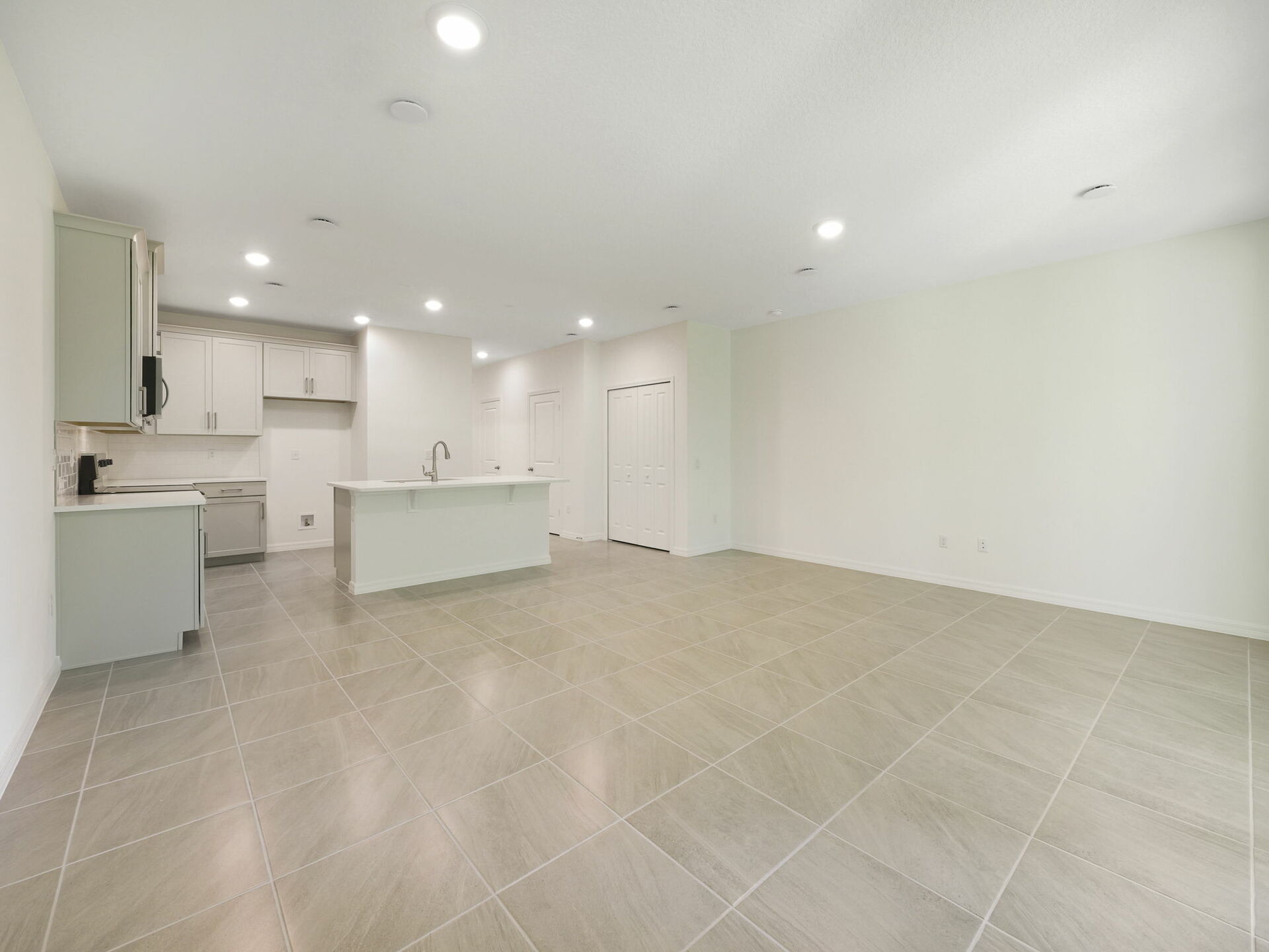room with view of kitchen and access to the lanai