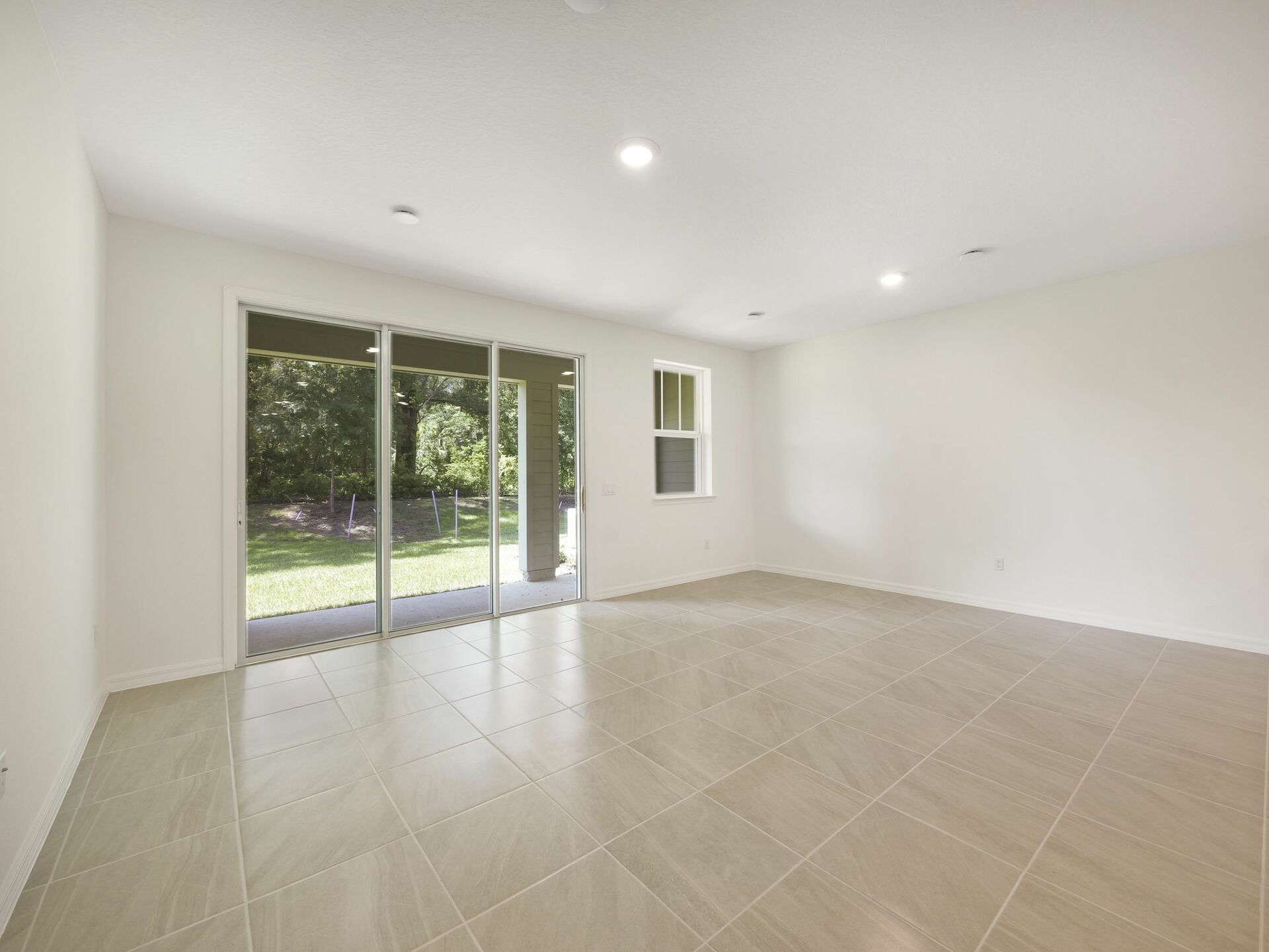 room with view of kitchen and access to the lanai