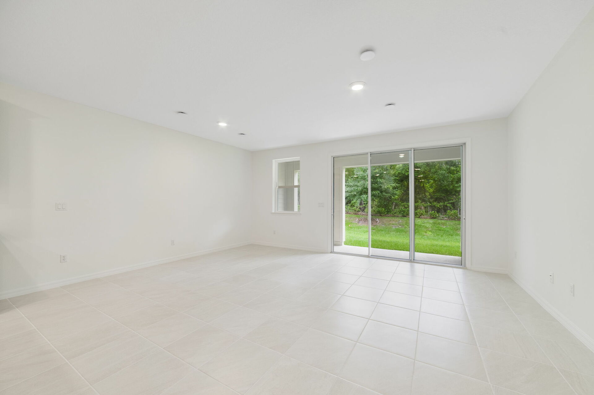 room with view of kitchen and access to the lanai