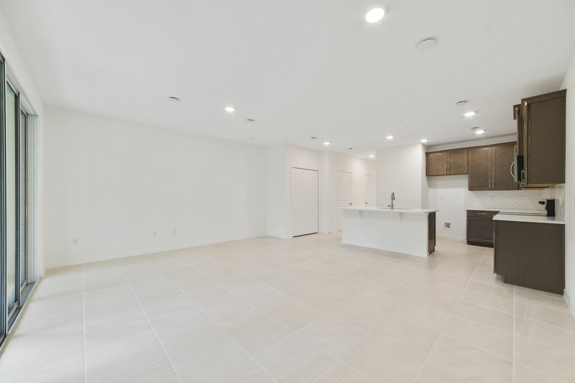 room with view of kitchen and access to the lanai