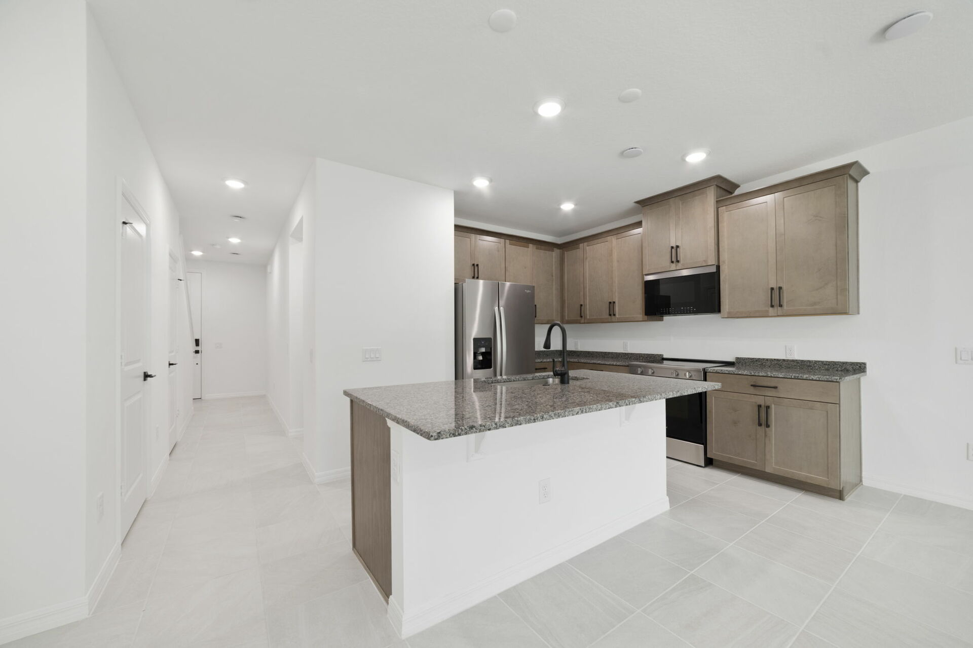 center island with stainless steel appliances and view of the great room