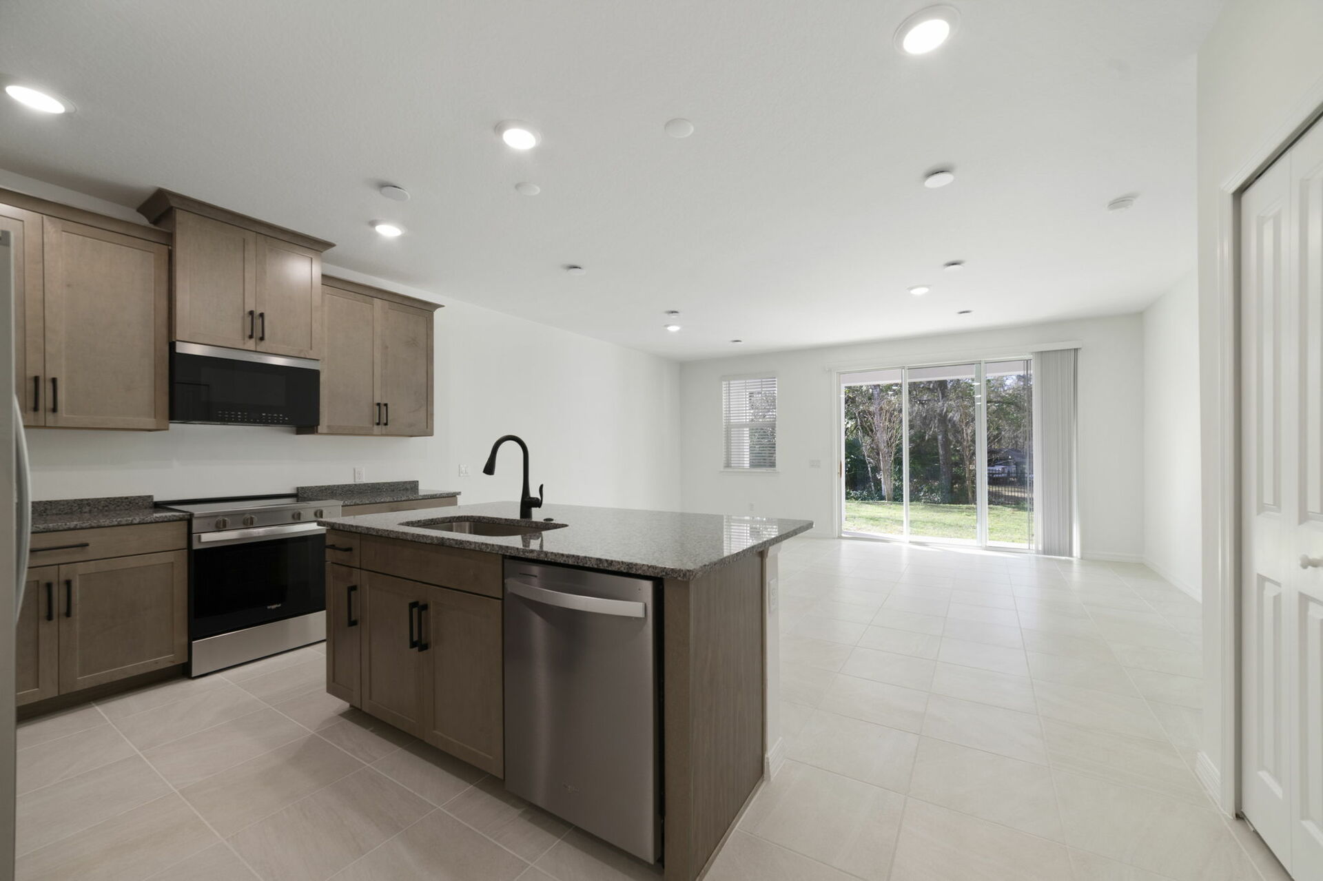 center island with stainless steel appliances and view of the great room