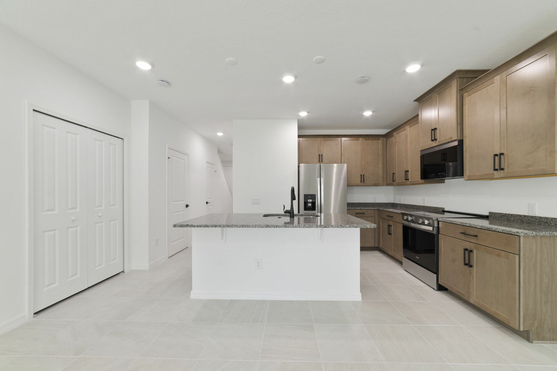 center island with stainless steel appliances and view of the great room