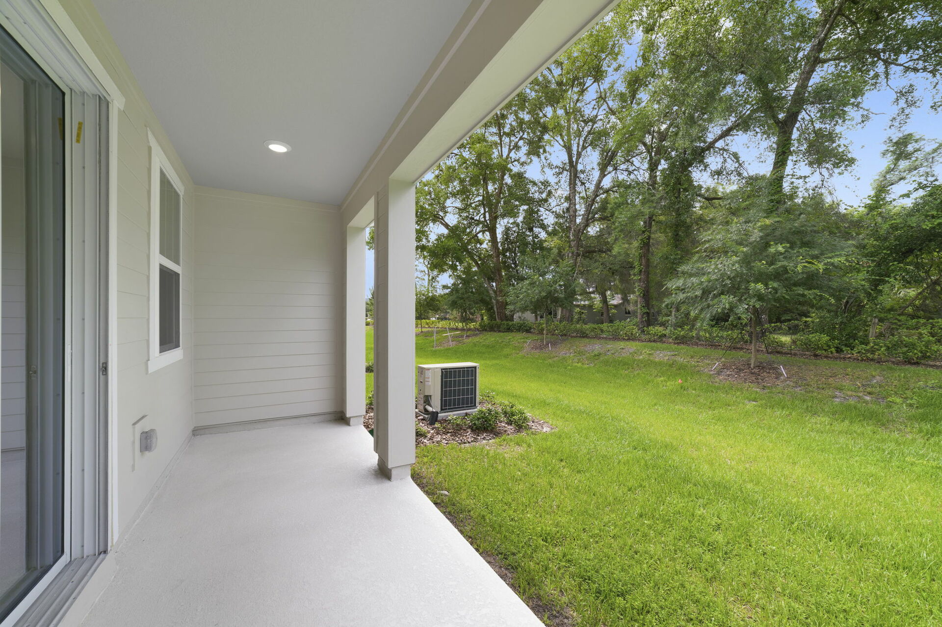 covered patio and backyard