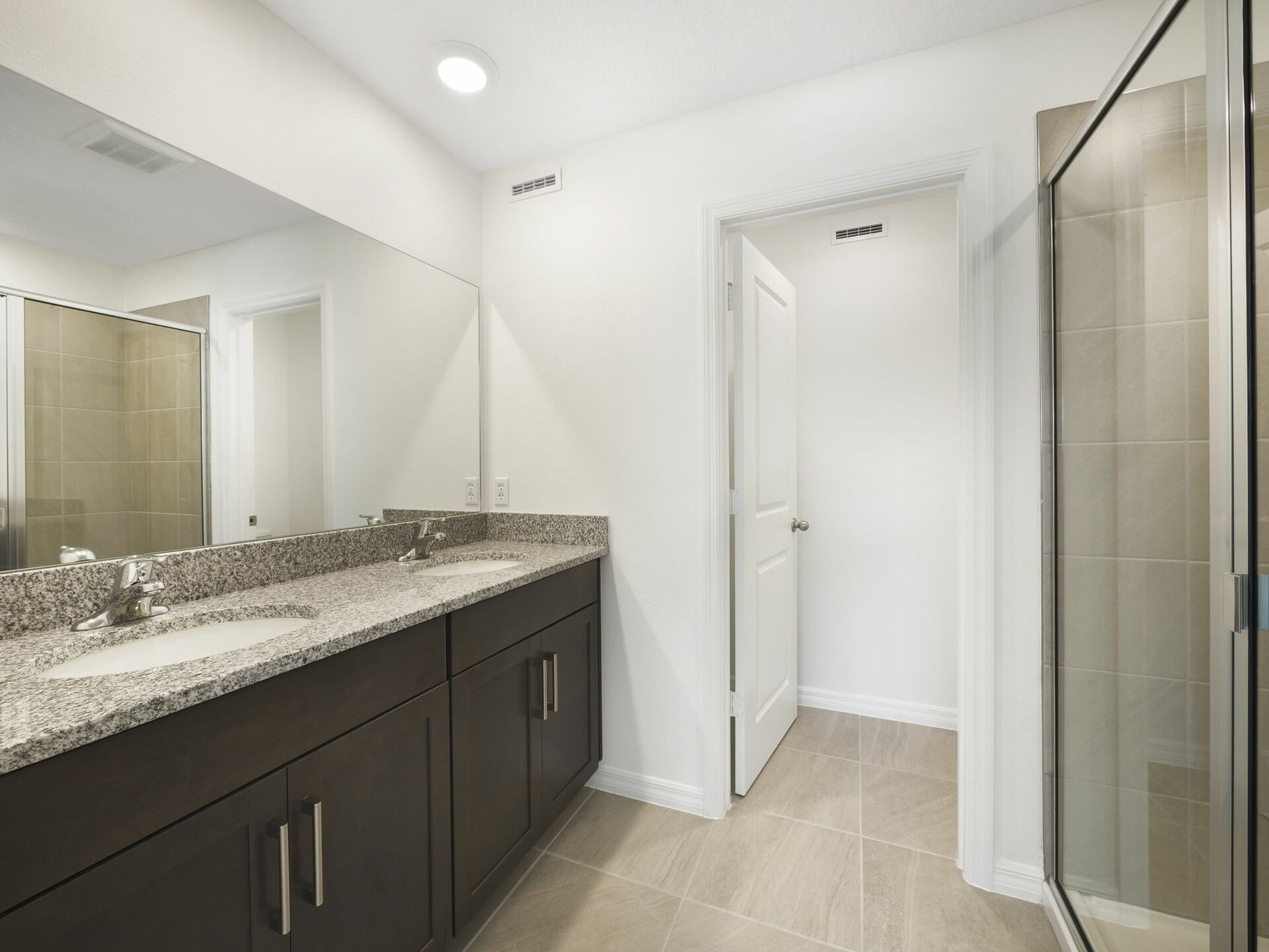 dual sink vanity, with shower and water closet