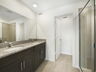 dual sink vanity, with shower and water closet