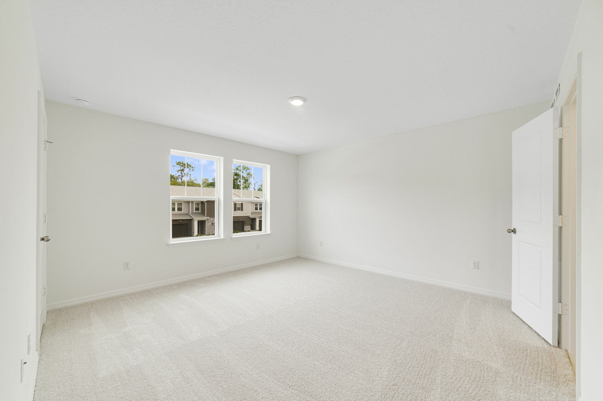 carpet throughout multiple windows and walk-in closet 