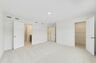 carpet throughout multiple windows and walk-in closet 