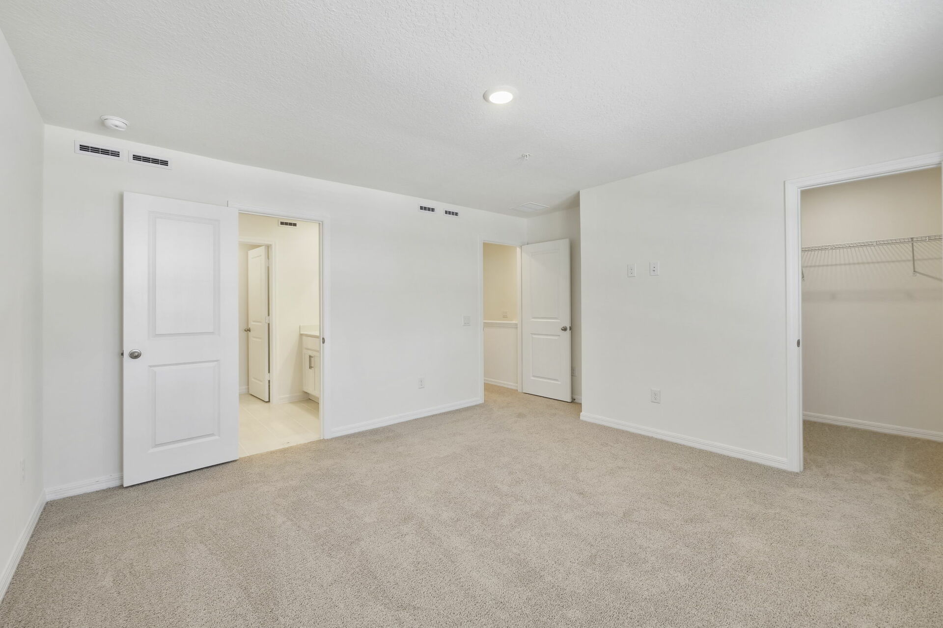 carpet throughout with a walk-in closet and 2 large windows