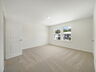 carpet throughout with dual windows and access to the primary bathroom