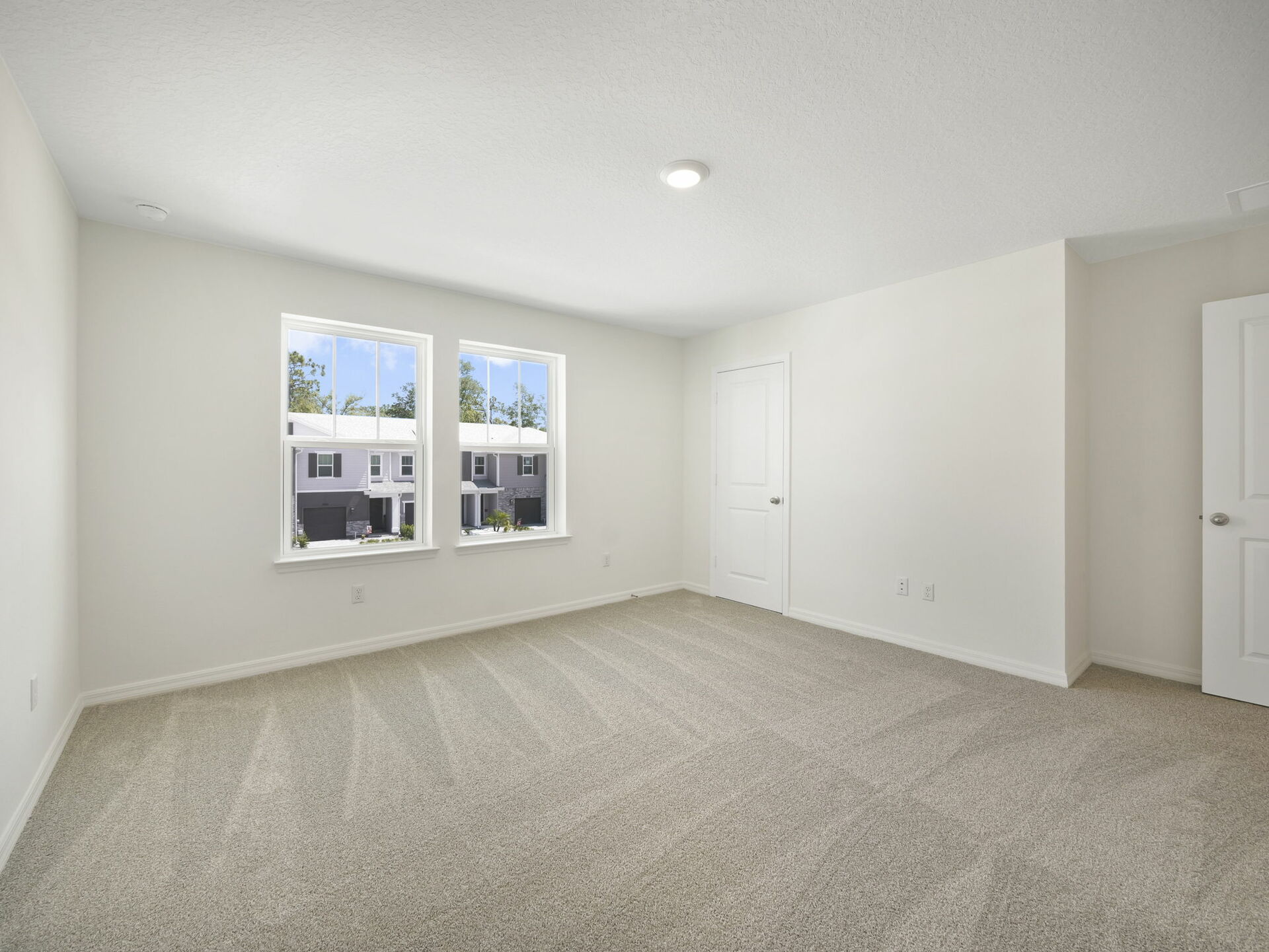 carpet throughout with dual windows and access to the primary bathroom