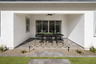 backyard patio with recessed lighting and black outdoor patio furniture.