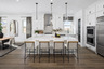 kitchen with white barstools, white quartz countertops, and stainless-steel appliances