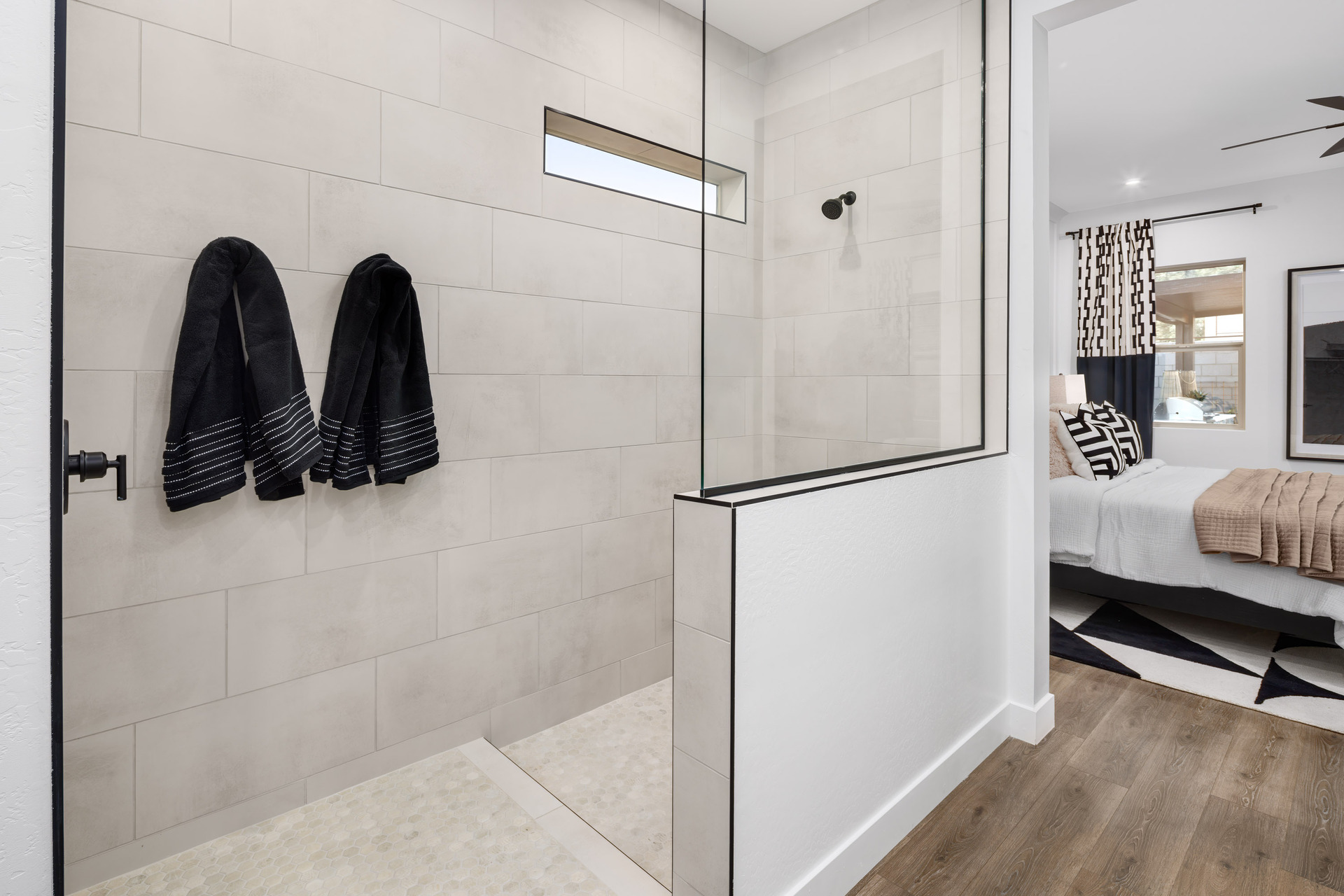 large walk-in shower with black hardware
