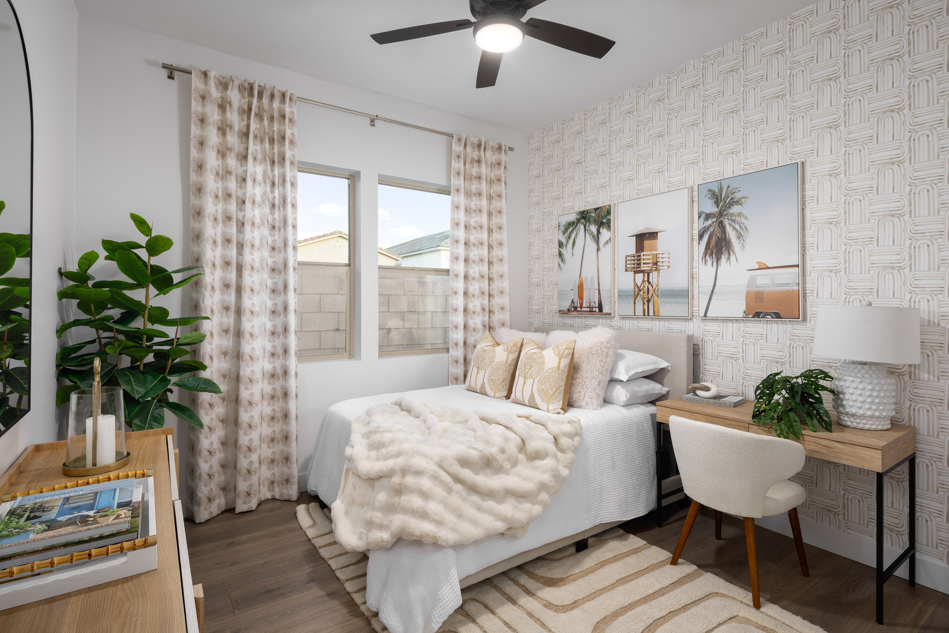 white bed with wooden desk and dresser