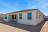spacious backyard and covered patio with recessed lights