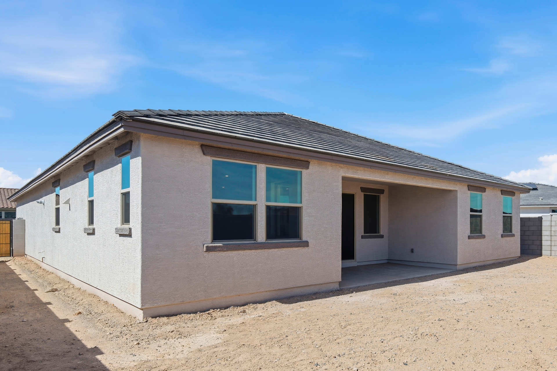spacious backyard and a covered patio with recessed lighting, ready for relaxation