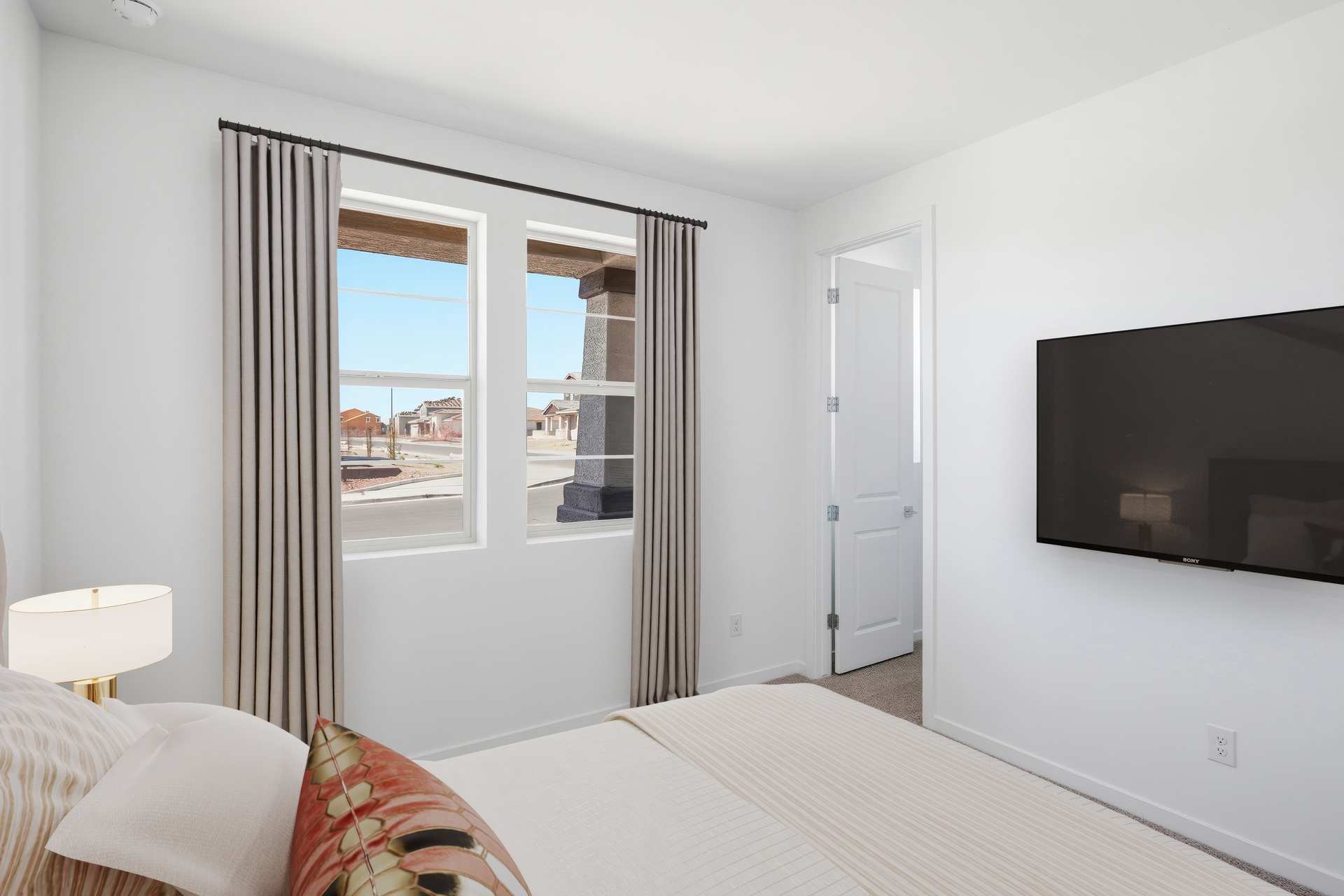 bedroom with a large bed and a neutral color palette.