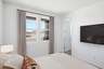 bedroom with a large bed and a neutral color palette.