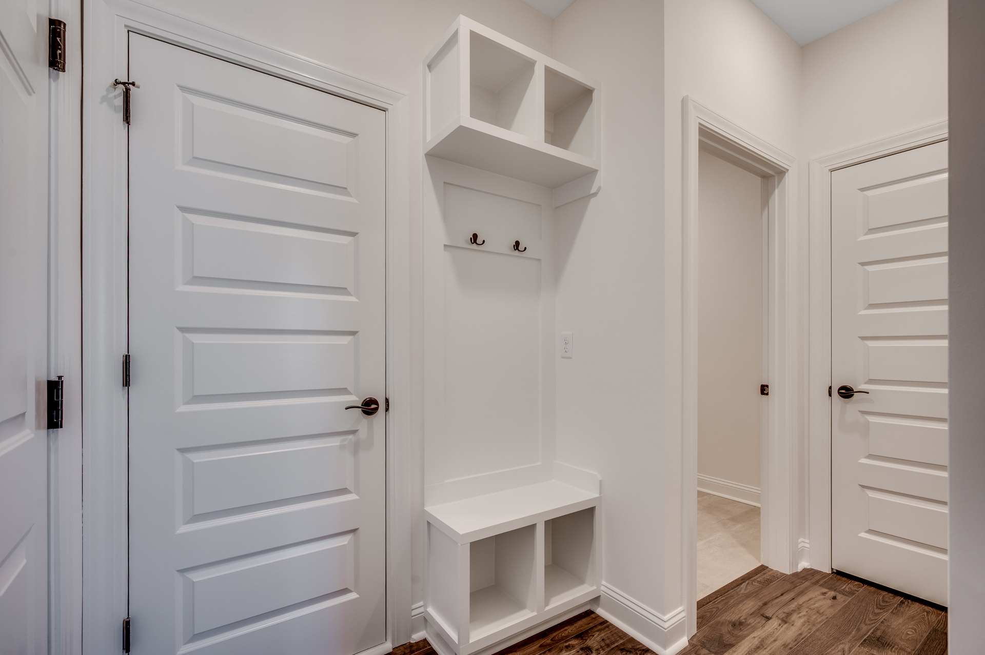 bright white built in shelving and seating area for additional storage 