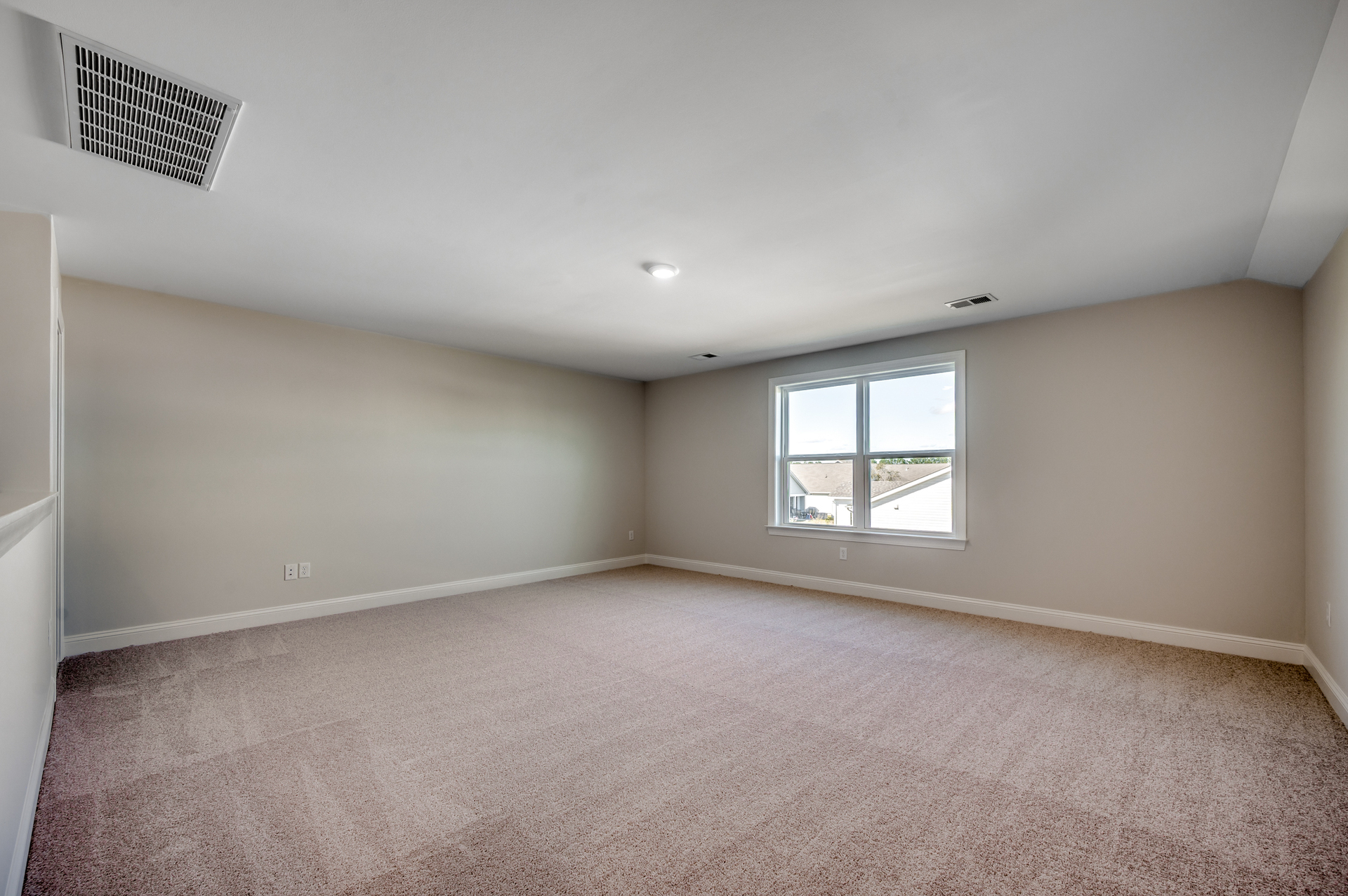 spacious upstairs area with light gray walls and carpeting throughout 