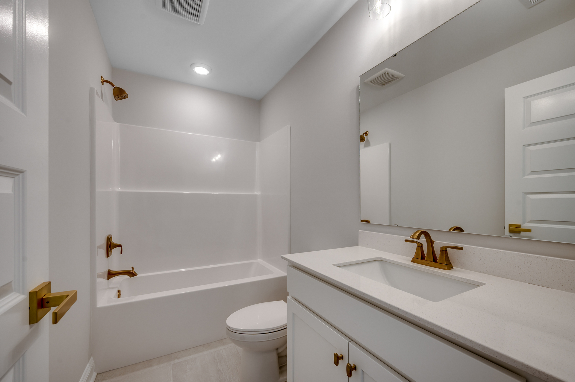 bright white bathroom on second floor with spacious shower and single sink vanity 