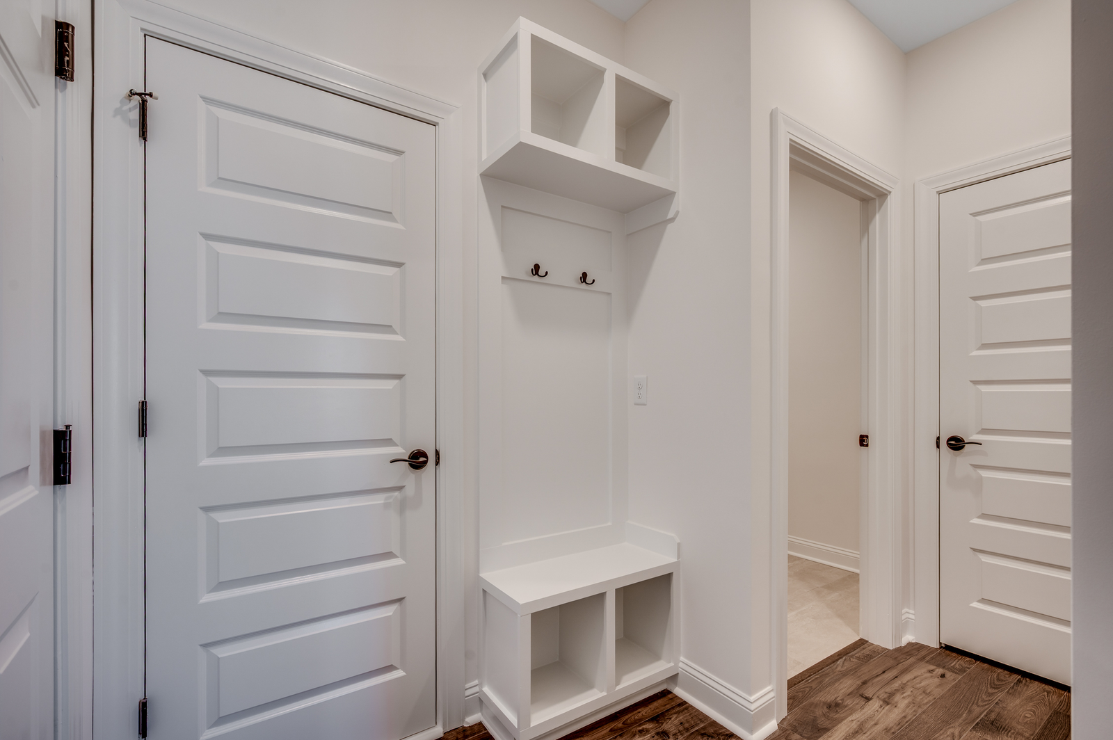 bright white built in shelving and seating area for additional storage