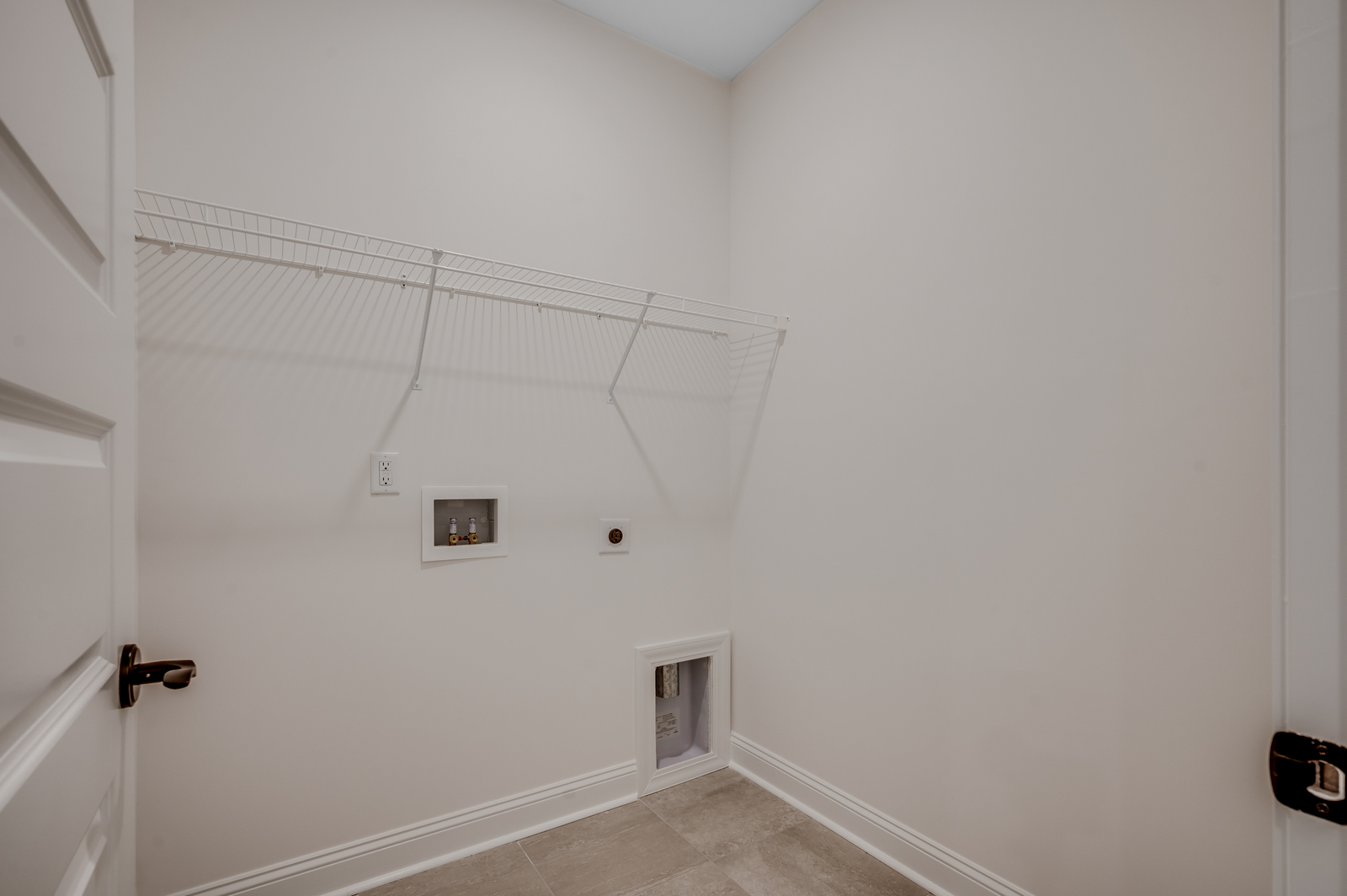 spacious room with bright walls and built in white wire shelving for extra storage