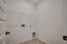 spacious room with bright walls and built in white wire shelving for extra storage